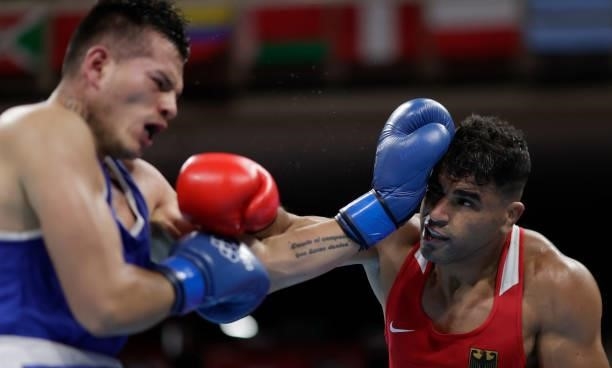 Ammar Riad Abduljabbar of Germany exchanges punches with Jose Maria Lucar Jaimes of Peru during the Men's Heavy on day four of the Tokyo 2020 Olympic...