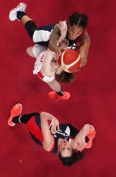 Gabrielle Williams of Team France and Saki Hayashi of Team Japan go up for a rebound as Sarah Michel of Team France looks on during a Women's...