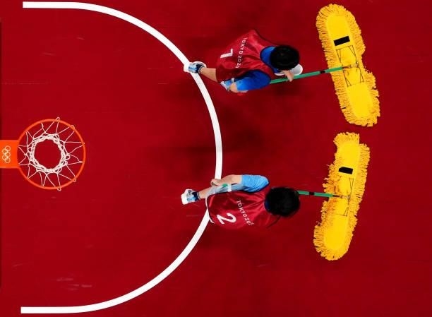 Court moppers clean the court during a time out during a Women's Preliminary Round Group B game between Japan and France on day four of the Tokyo...