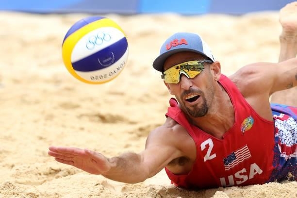 Nicholas Lucena of Team United States returns against Team Brazil during the Men's Preliminary - Pool D beach volleyball on day four of the Tokyo...
