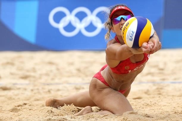 Heather Bansley of Team Canada dives to return the ball against Team Argentina during the Women's Preliminary - Pool C beach volleyball on day four...