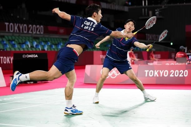 Choi Solgyu and Seo Seungjae of Team South Korea compete against Mohammad Ahsan and Hendra Setiawan of Team Indonesia during a Men's Doubles Group D...