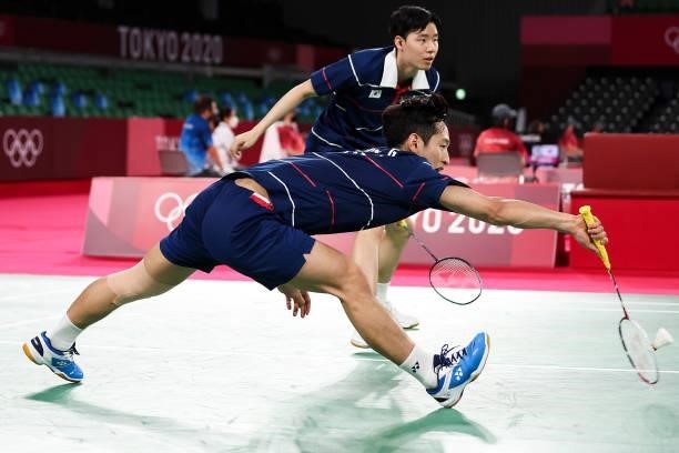 Choi Solgyu and Seo Seungjae of Team South Korea compete against Mohammad Ahsan and Hendra Setiawan of Team Indonesia during a Men's Doubles Group D...