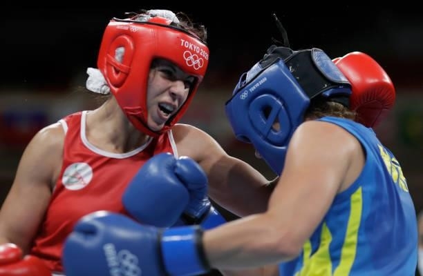 Oumayma Bel Ahbib of Morocco exchanges punches with Anna Lysenko of Ukraine during the Women's Welter on day four of the Tokyo 2020 Olympic Games at...