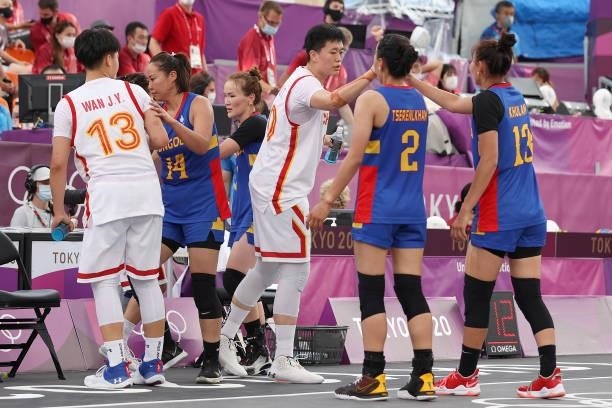 Zhiting Zhang of Team China and Khulan Onolbaatar of Team Mongolia react with team mates after the game in the 3x3 Basketball competition on day four...