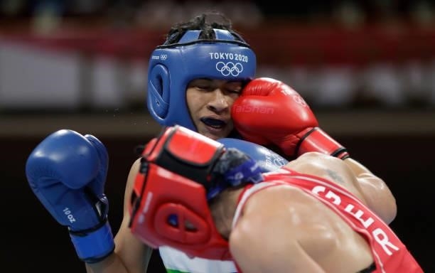 Nadine Apetz of Germany exchanges punches with Lovlina Borgohain of India during the Women's Welter on day four of the Tokyo 2020 Olympic Games at...