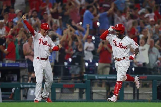 Andrew McCutchen of the Philadelphia Phillies rounds third base after he hit a walk off three-run home run in the ninth inning of a game against the...