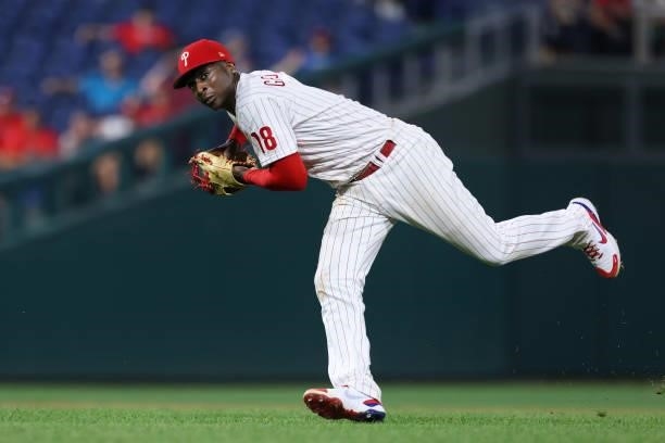 Shortstop Didi Gregorius of the Philadelphia Phillies attempts to throw after making an error on a ball hit by Josh Bell of the Washington Nationals...