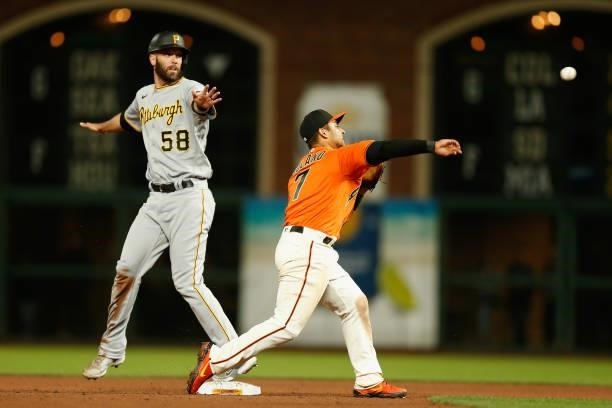 Jacob Stallings of the Pittsburgh Pirates is safe at second base as Donovan Solano of the San Francisco Giants is unable to get the out at second...