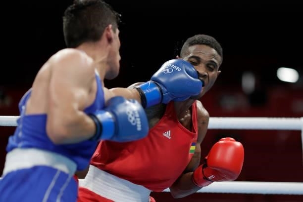 Merven Clair of Mauritius exchanges punches with Zeyad Eishaih Hussein of Jordan during the Men's Welter on day four of the Tokyo 2020 Olympic Games...