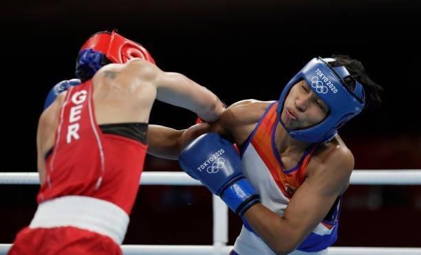 Nadine Apetz of Germany exchanges punches with Lovlina Borgohain of India during the Women's Welter on day four of the Tokyo 2020 Olympic Games at...