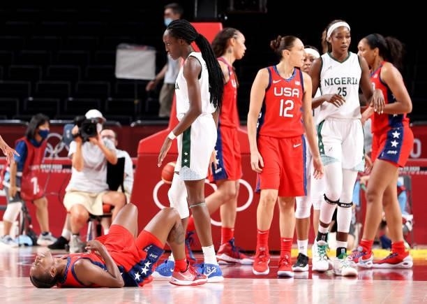 Jewell Loyd of Team United States lays on the court as Ify Ibekwe of Team Nigeria stands over her during the second half of a Women's Preliminary...
