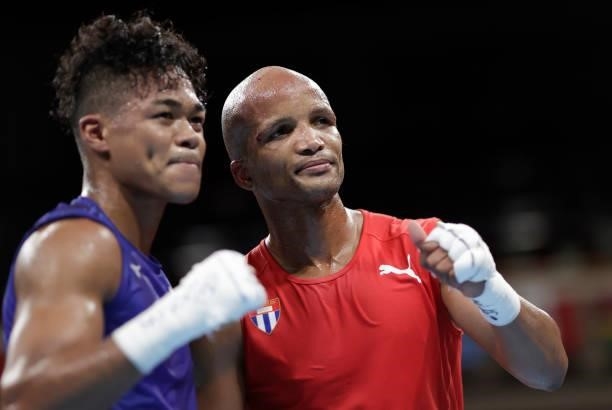 Roniel Iglesia of Cuba exchanges and Sewonrets Quincy Mensah Okazawa of Japan pose after the Men's Welter on day four of the Tokyo 2020 Olympic Games...