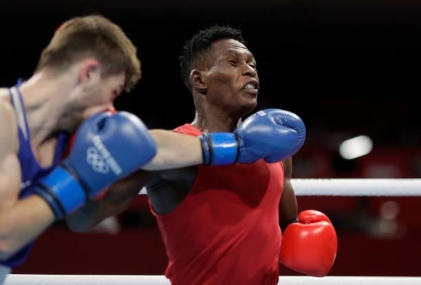 Shadiri Bwogi of Uganda exchanges punches with Eskerkhan Madiev of Georgia during the Men's Welter on day four of the Tokyo 2020 Olympic Games at...