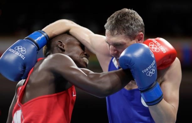 Stephen Zimba of Zimbabwe exchanges punches with Andrei Zamkovoi of Russian Olympic Committee during the Men's Welter on day four of the Tokyo 2020...