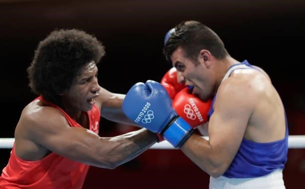 Julio Cesar Castillo Torres of Ecuador exchanges punches with Hussein Eishaish Hussein Iashaish of Jordan during the Men's Heavy on day four of the...