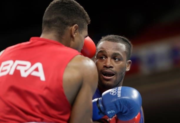 Abner Teixeira of Brazil exchanges punches with Cheavon Clarke of Great Britain during the Men's Heavy on day four of the Tokyo 2020 Olympic Games at...