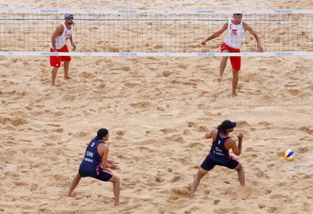 Michal Bryl and Grzegorz Fijalek of Team Poland compete against Marco Grimalt and Esteban Grimalt of Team Chile during the Men's Preliminary - Pool E...