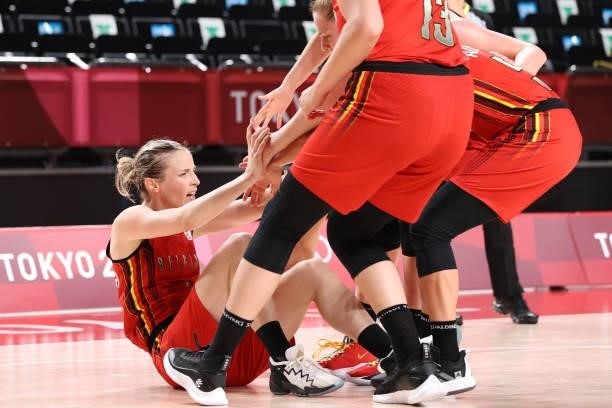 Kim Mestdagh of Team Belgium is helped up from the court by her teammates during the second half of their Women's Preliminary Round Group C game...
