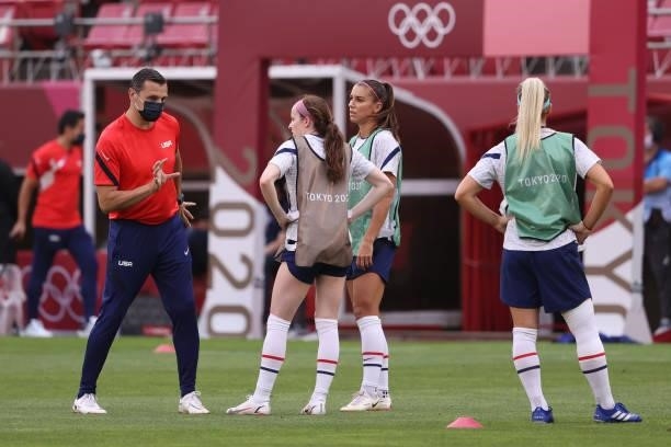 Vlatko Andonovski, Head Coach of Team United States speaks with Rose Lavelle and Alex Morgan of Team United States during the warm up prior to the...