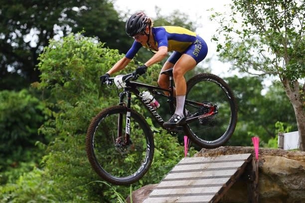 Jenny Rissveds of Team Sweden jumps during the Women's Cross-country race on day four of the Tokyo 2020 Olympic Games at Izu Mountain Bike Course on...