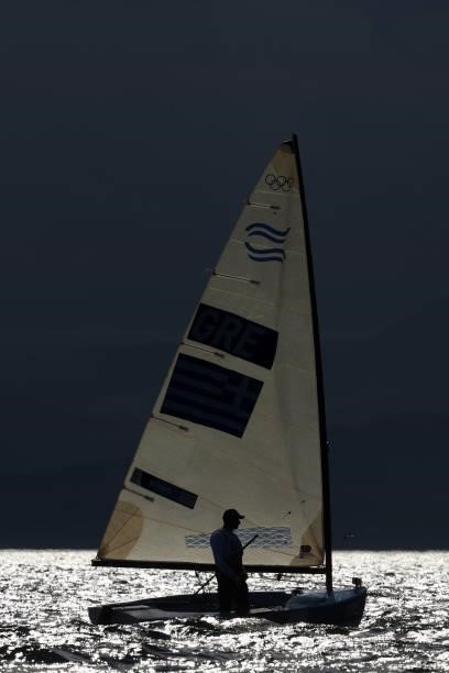 Ioannis Mitakis of Team Greece returns to shore after competing in the Men's Finn class on day four of the Tokyo 2020 Olympic Games at Enoshima Yacht...