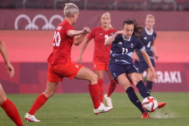 Caroline Weir of Team Great Britain shoots whilst under pressure from Sophie Schmidt of Team Canada during the Women's Group E match between Canada...