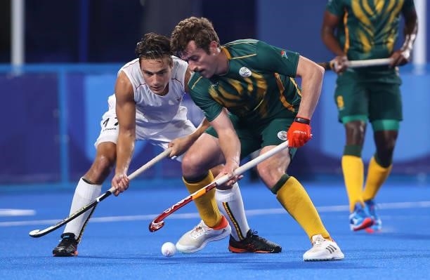 Thomas Briels of Team Belgium and Matthew Guise-Brown of Team South Africa battle for the ball during the Men's Preliminary Pool B match between...
