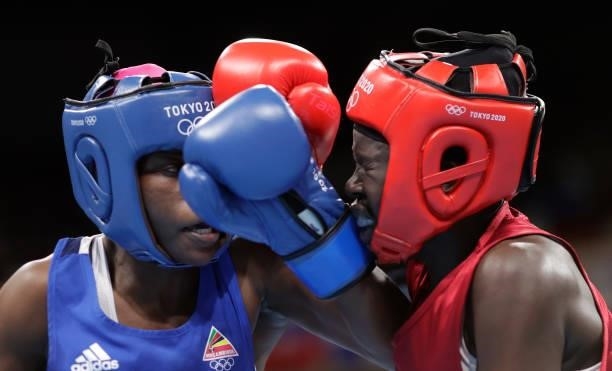Elizabeth Akinyi of Kenya exchanges punches with Alcinda Helena Panguana of Mozambique during the Women's Welter on day four of the Tokyo 2020...