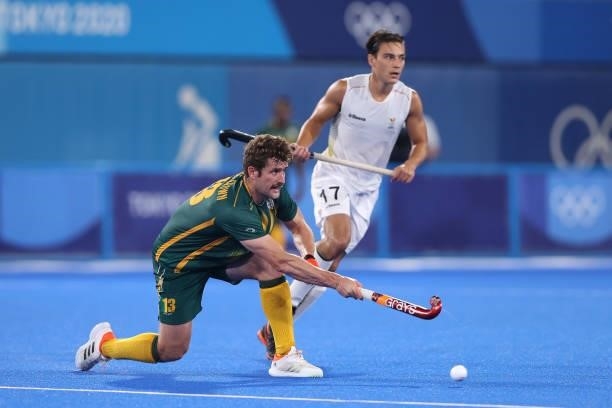 Matthew Guise-Brown of Team South Africa passes the ball whilst under pressure from Thomas Briels of Team Belgium during the Men's Preliminary Pool B...