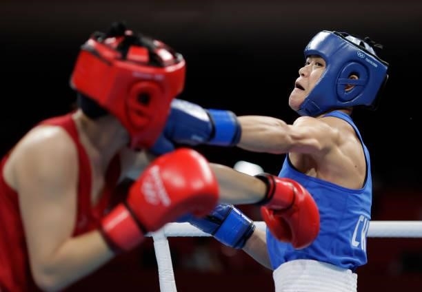 Baison Manikon of Thailand exchanges punches with Hong Gu of China during the Women's Welter on day four of the Tokyo 2020 Olympic Games at Kokugikan...