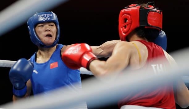 Baison Manikon of Thailand exchanges punches with Hong Gu of China during the Women's Welter on day four of the Tokyo 2020 Olympic Games at Kokugikan...