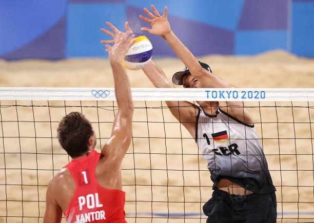Julius Thole of Team Germany competes with Piotr Kantor of Team Poland during the Men's Preliminary - Pool F beach volleyball on day four of the...