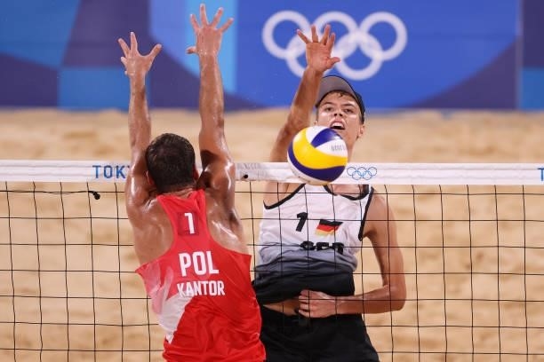 Julius Thole of Team Germany competes with Piotr Kantor of Team Poland during the Men's Preliminary - Pool F beach volleyball on day four of the...
