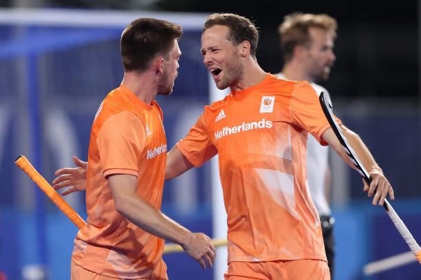 Thierry Brinkman of Team Netherlands celebrates with teammate Roel Bovendeert after scoring their team's second goal during the Men's Preliminary...