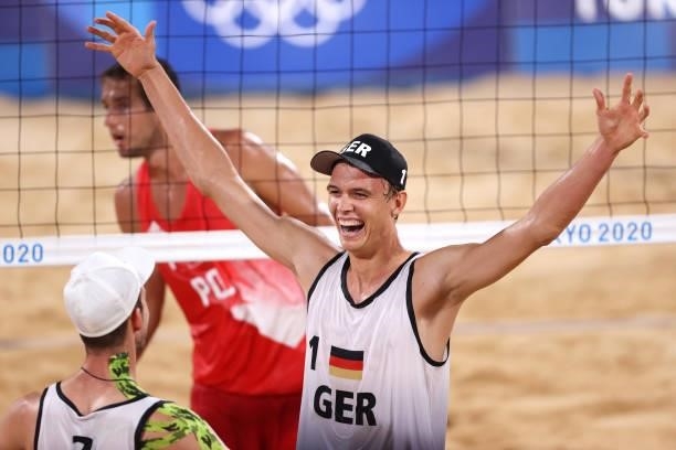 Julius Thole and Clemens Wickler of Team Germany react after defeating Team Poland during the Men's Preliminary - Pool F beach volleyball on day four...