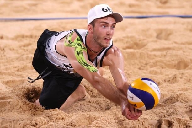 Clemens Wickler of Team Germany competes against Team Poland during the Men's Preliminary - Pool F beach volleyball on day four of the Tokyo 2020...
