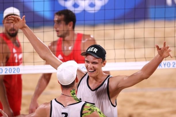 Julius Thole and Clemens Wickler of Team Germany react after defeating Team Poland during the Men's Preliminary - Pool F beach volleyball on day four...