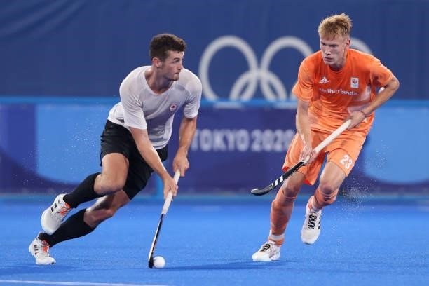 James Brodie Burns Wallace of Team Canada holds the ball whilst under pressure from Joep Paul Eric de Mol of Team Netherlands during the Men's...