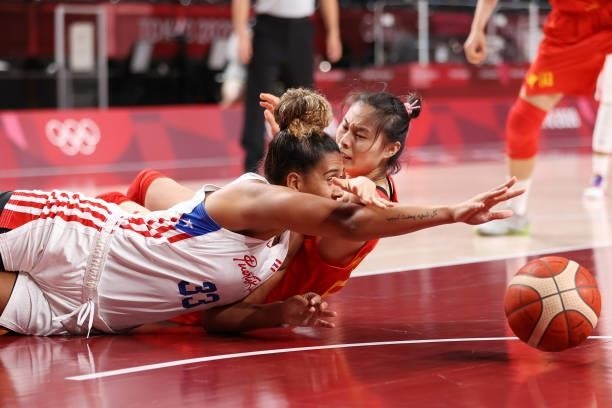 India Pagan of Team Puerto Rico and Siyu Wang of Team China scramble on the floor for possession of a loose ball during the first half of a Women's...