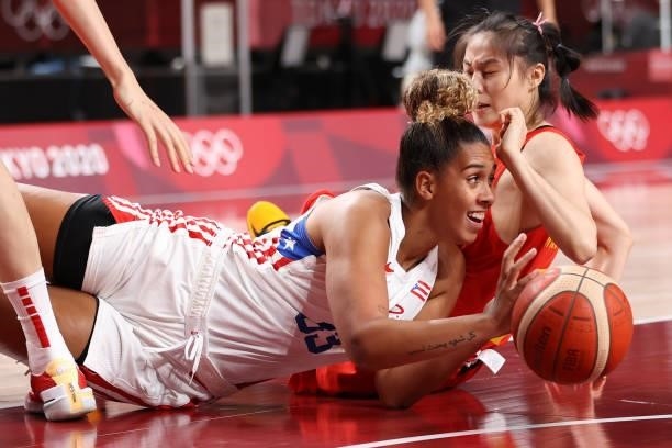 India Pagan of Team Puerto Rico and Siyu Wang of Team China scramble on the floor for possession of a loose ball during the first half of a Women's...