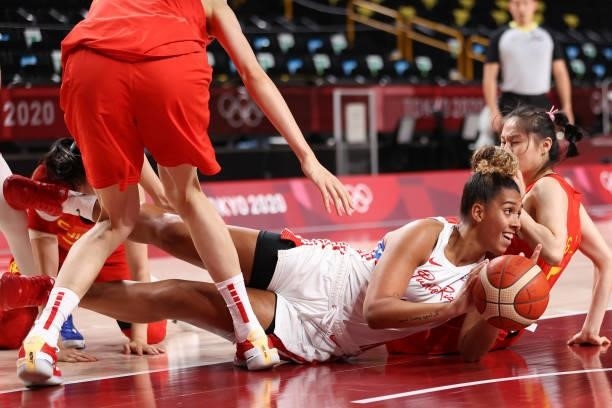 India Pagan of Team Puerto Rico scrambles on the floor for possession of a loose ball against China during the first half of a Women's Preliminary...