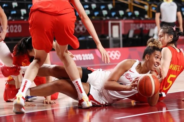 India Pagan of Team Puerto Rico scrambles on the floor for possession of a loose ball against China during the first half of a Women's Preliminary...