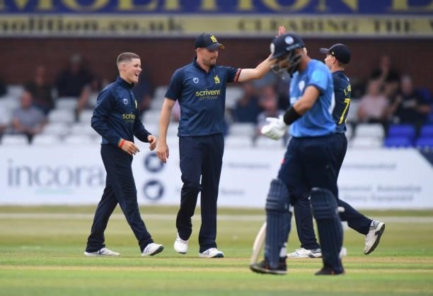 Jacob Bethell and Will Rhodes of Warwickshire celebrate taking the wicket of Anuj Dal of Derbyshire during the Royal London Cup match between...