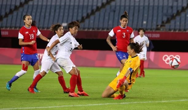 Mina Tanaka of Team Japan scores their side's first goal during the Women's Group E match between Chile and Japan on day four of the Tokyo 2020...