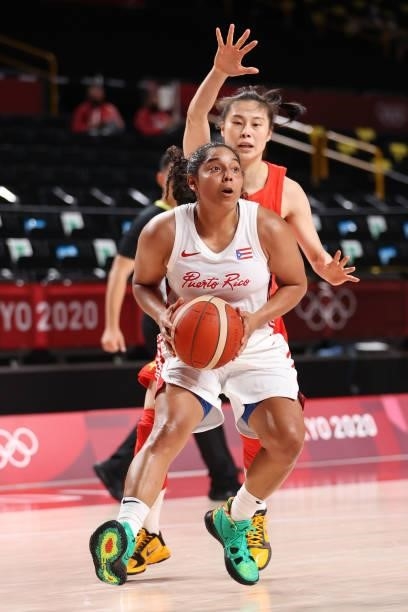 Jennifer O'Neill of Team Puerto Rico drives to the basket against China during the first half of a Women's Preliminary Round Group C game on day four...