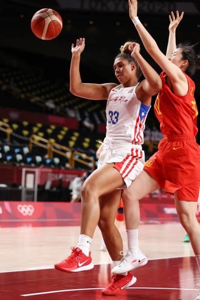 India Pagan of Team Puerto Rico loses possession of the ball as she drives to the basket against Zhenqi Pan of Team China during the first half of a...