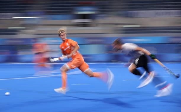 Jonas de Geus of Team Netherlands chases the ball under pressure from Mark Alistair John Pearson of Team Canada during the Men's Preliminary Pool B...
