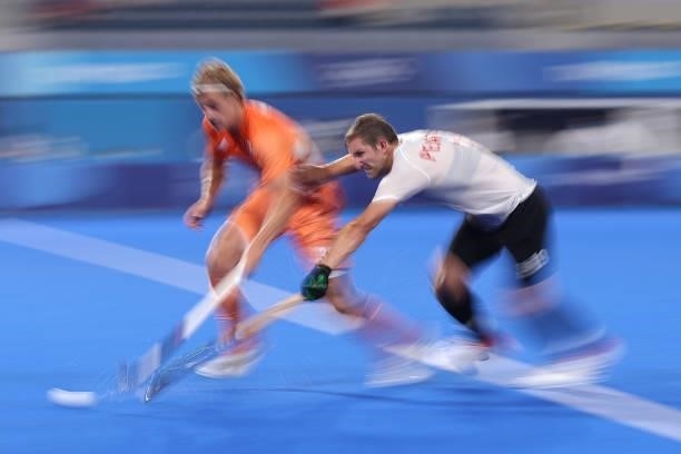 Jonas de Geus of Team Netherlands and Mark Alistair John Pearson of Team Canada battle for the ball during the Men's Preliminary Pool B match between...