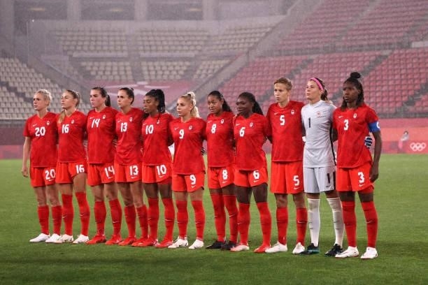 Players of Team Canada stand for the national anthem prior to the Women's Group E match between Canada and Great Britain on day four of the Tokyo...